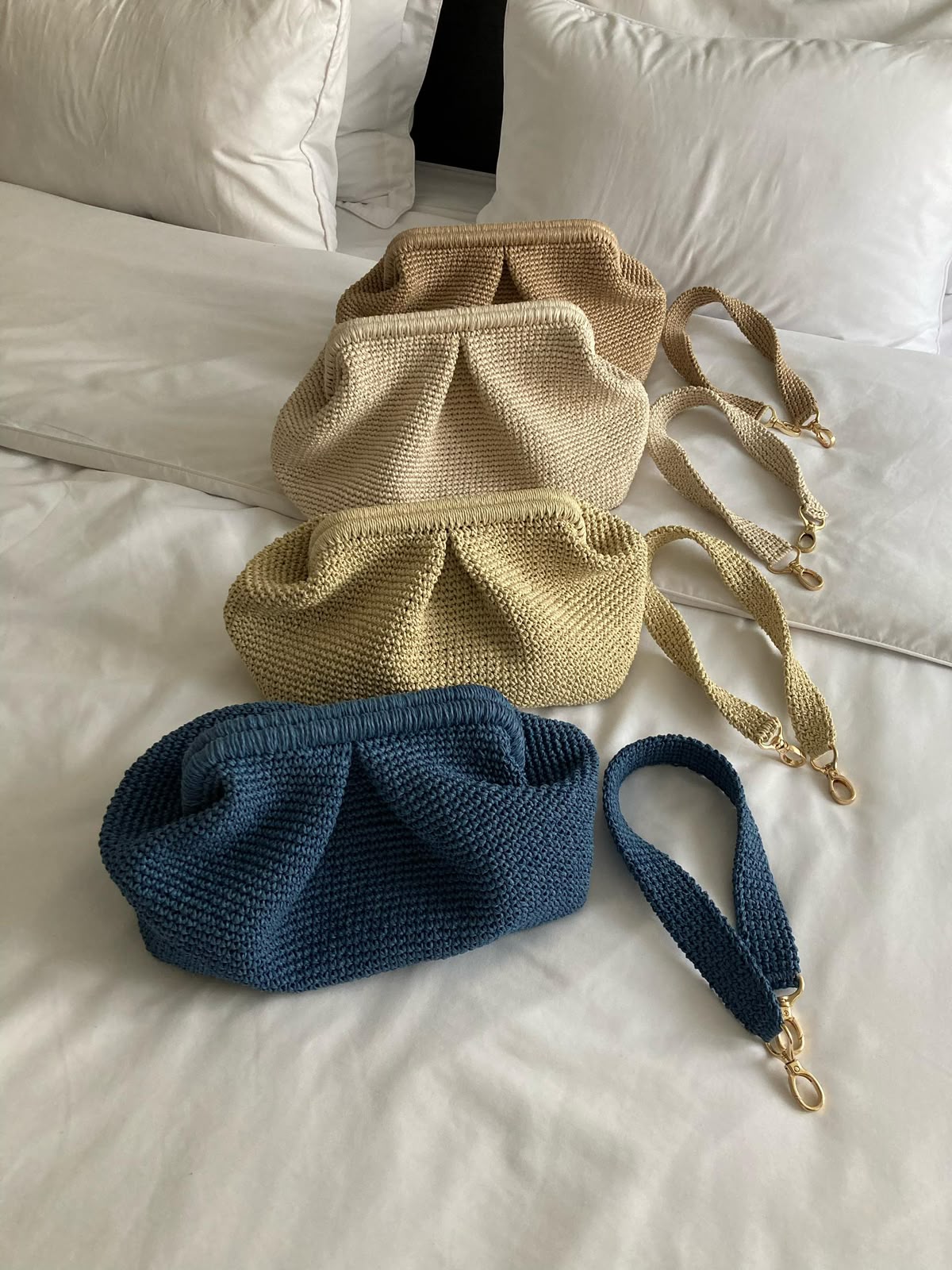 Three TarNina handcrafted cloud-shaped pouches in tan, cream, and teal tones, with matching crossbody straps